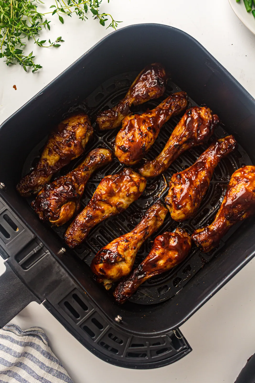 Glazed drumsticks arranged in the basket, ready to crisp