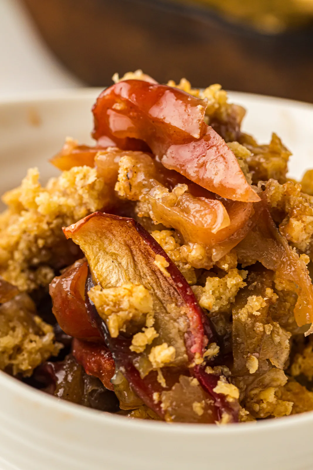 Serving of apple crisp in a white bowl