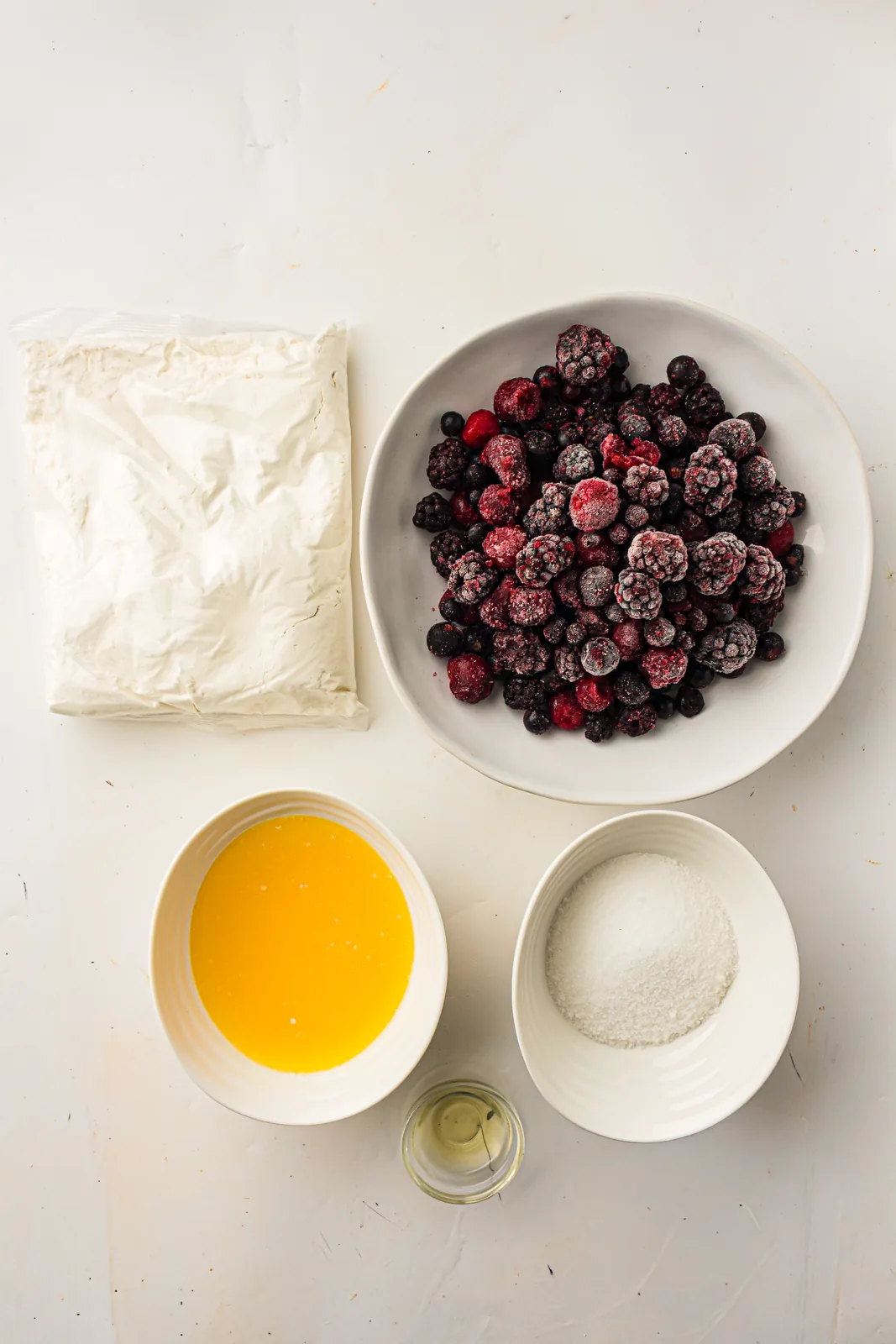 Ingredients for berry dump cake: mixed berries, cake mix and butter
