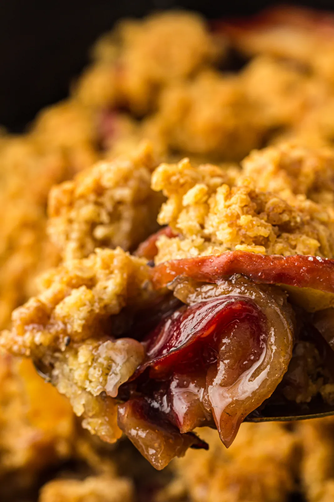 Tender baked apples and a crisp oat topping lifted on a fork