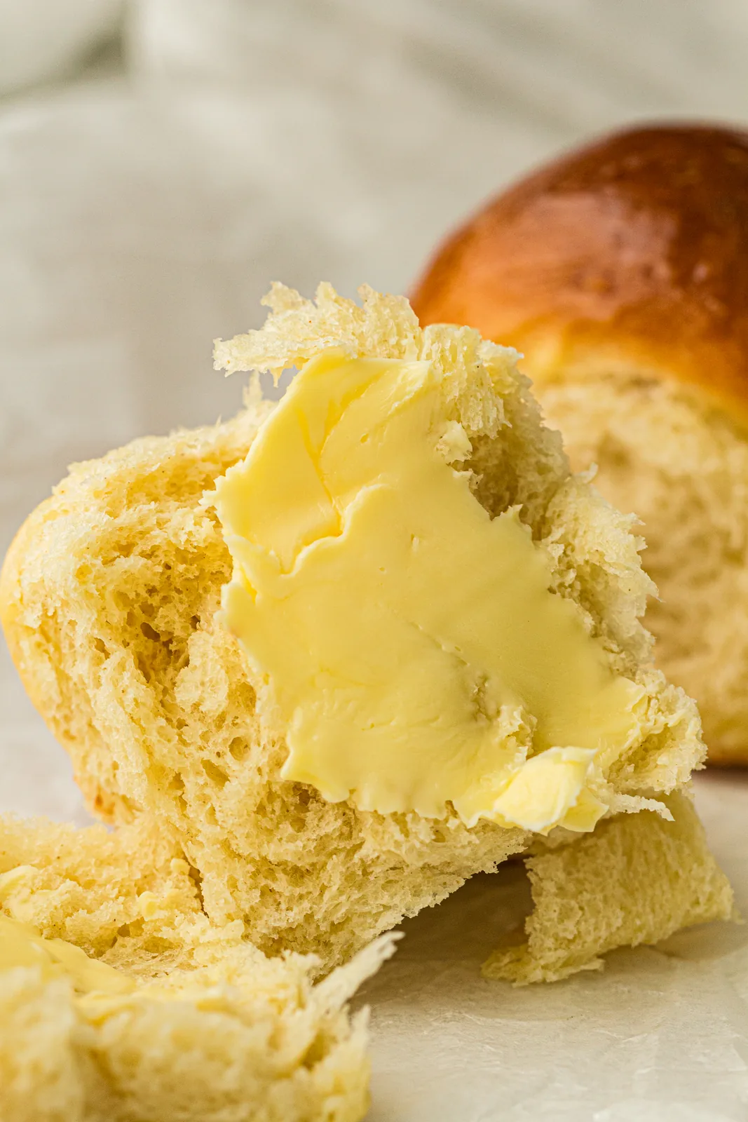 Close up of a pull-apart roll brushed with melted butter
