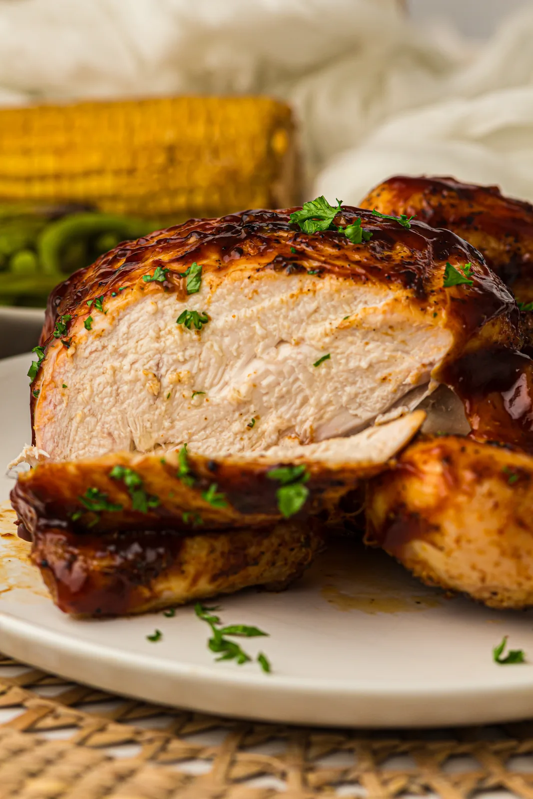 Carved juicy white and dark meat piled on a white plate