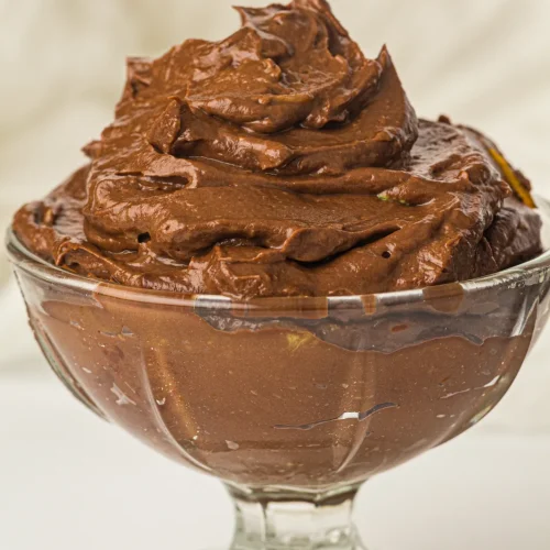 Chocolate avocado mousse swirled in a glass dessert dish