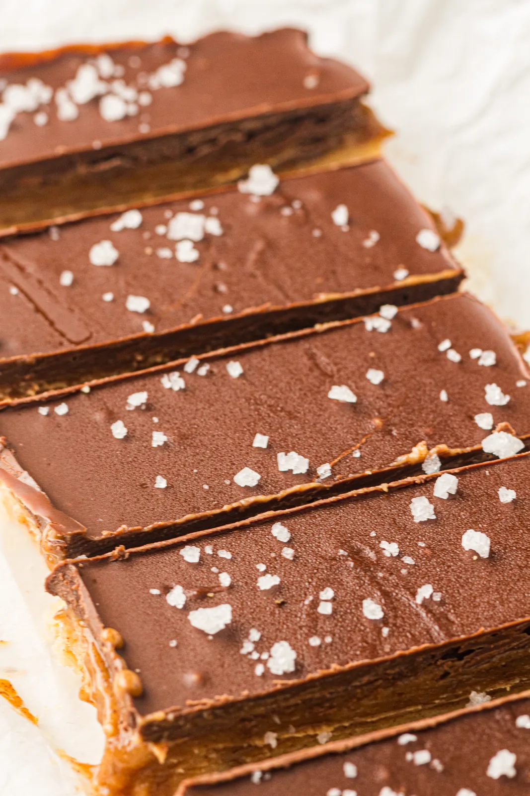 Sliced chocolate caramel bars topped with flaky sea salt
