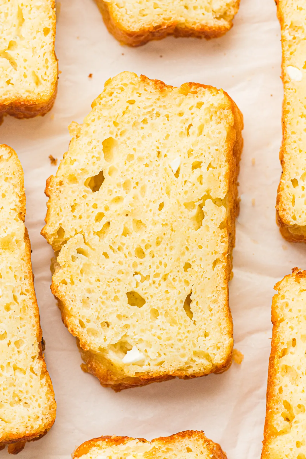 Golden loaf on a wooden board, sliced to show the soft crumb