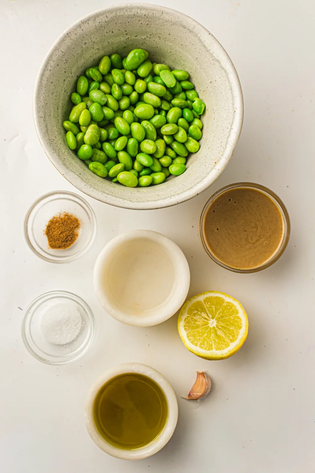 Ingredients for edamame hummus: edamame, tahini, lemon, garlic, and olive oil