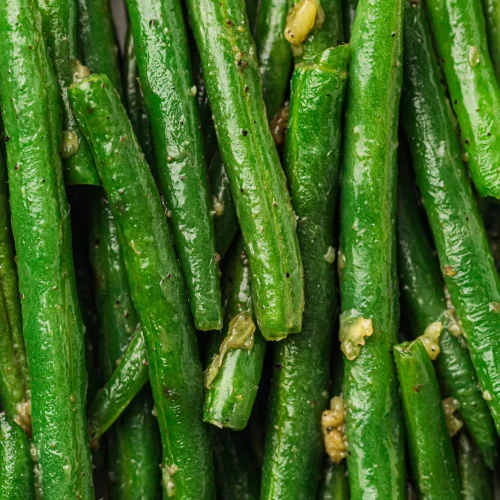 Garlic butter green beans, glossy and speckled with black pepper