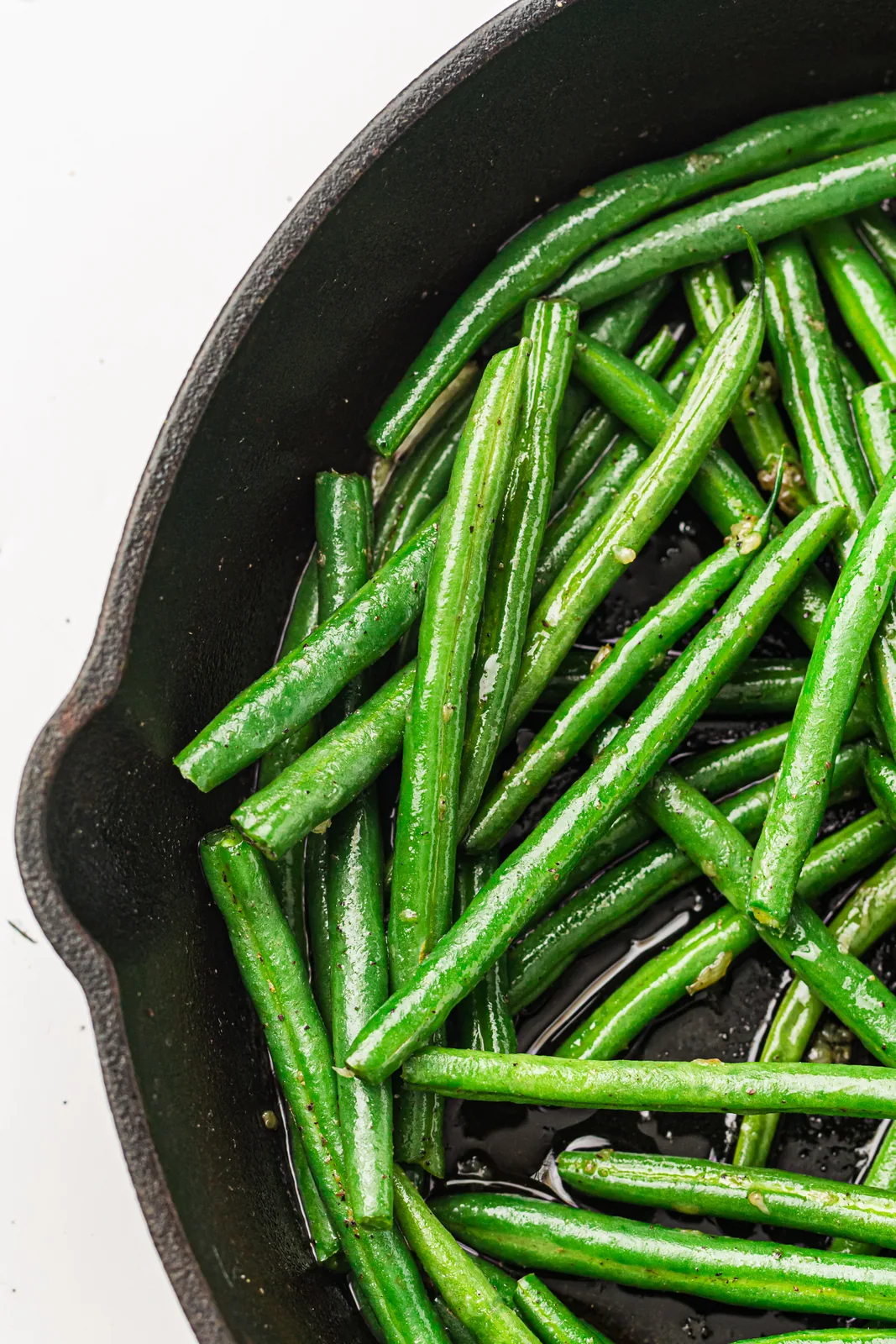 Green beans tossed in a cast iron skillet