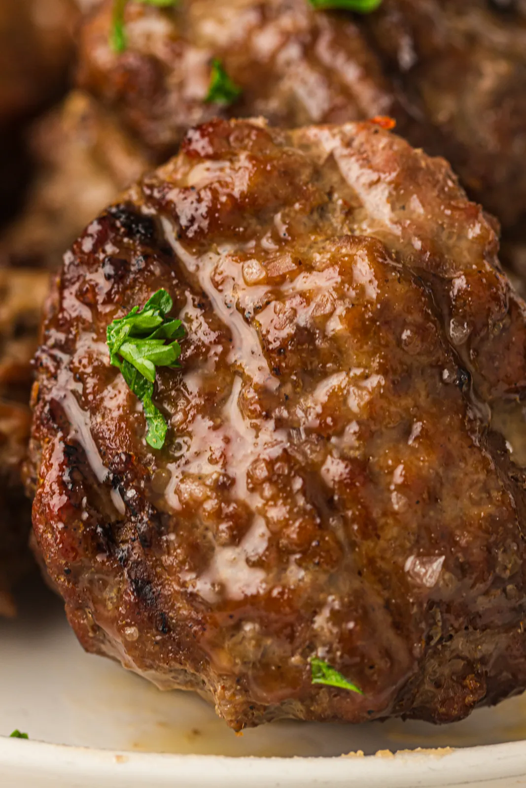 A single seasoned beef patty on a plate
