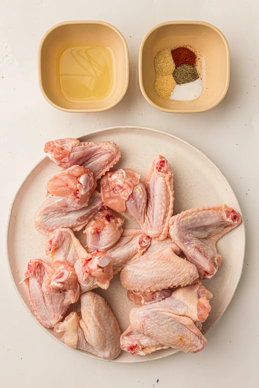 Ingredients for grilled chicken wings: wings, olive oil, smoked paprika, garlic powder, onion powder, salt, and pepper