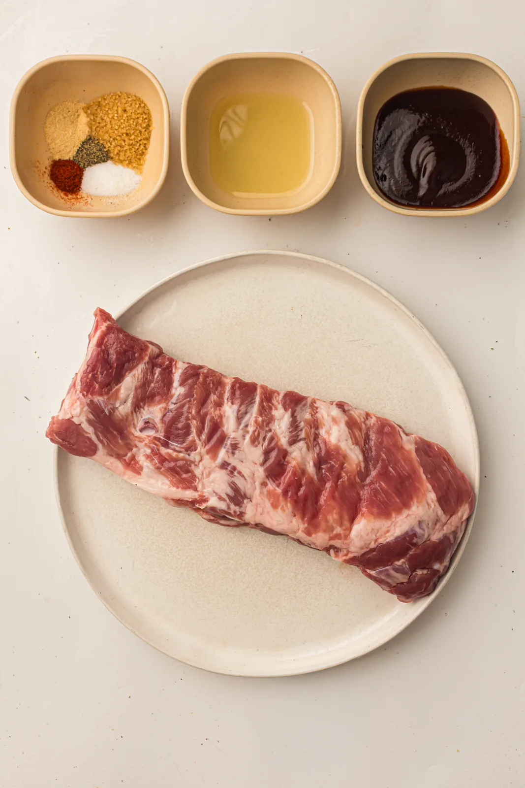 Brown sugar, smoked paprika, garlic powder, salt, pepper, and oil for a barbecue rub