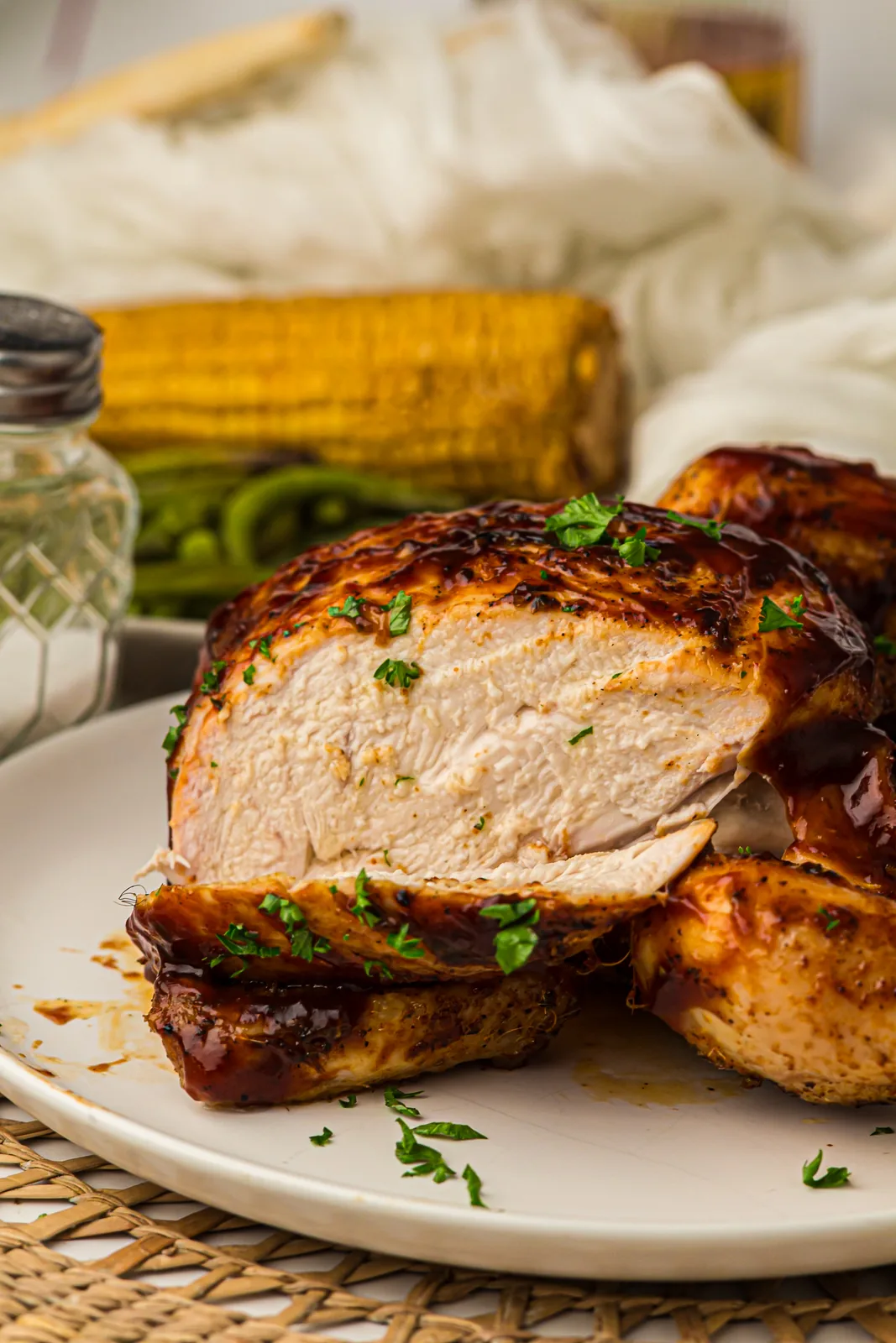 Juicy grilled whole chicken sliced to show the tender white breast meat