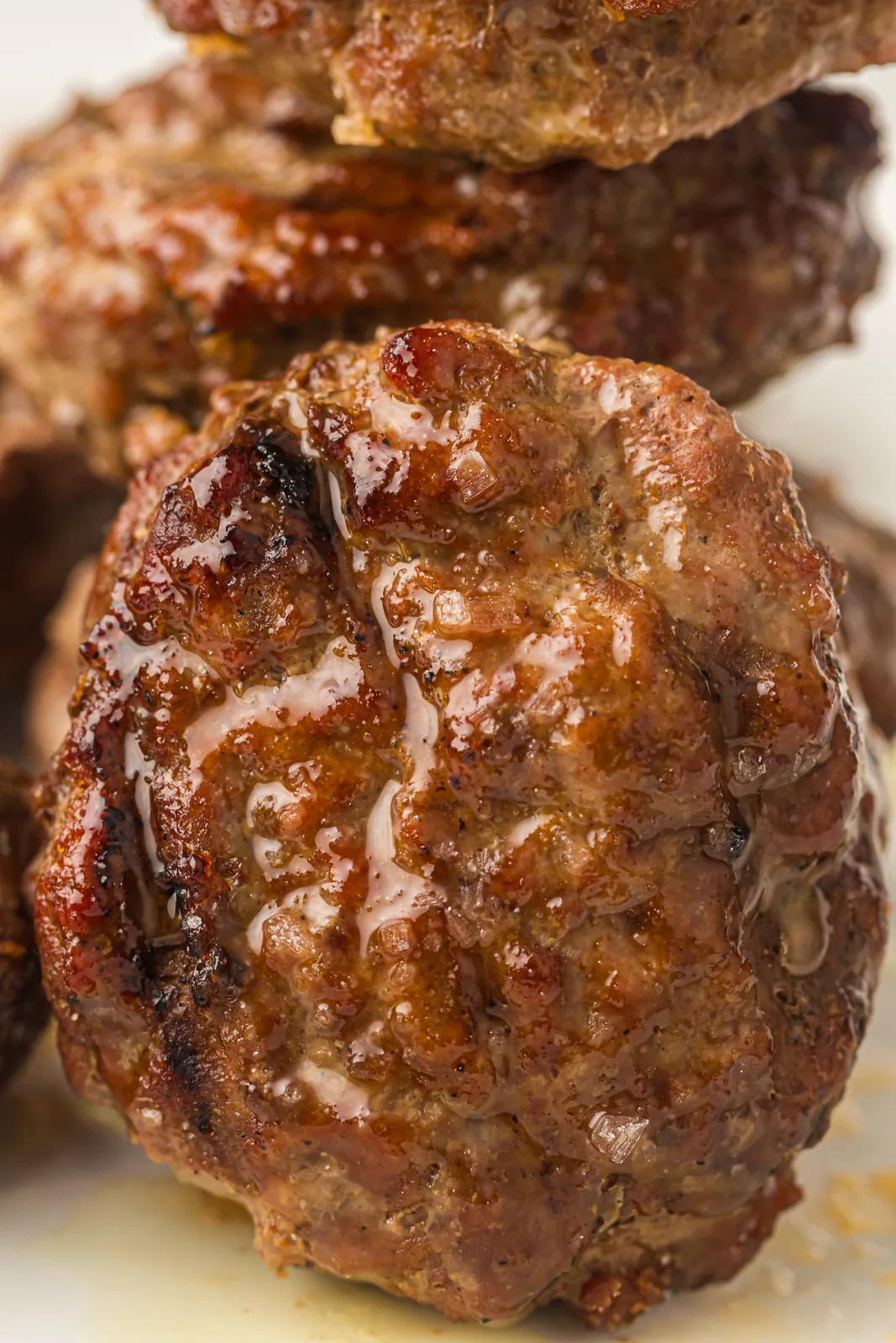 Close up of a juicy beef patty with a charred crust
