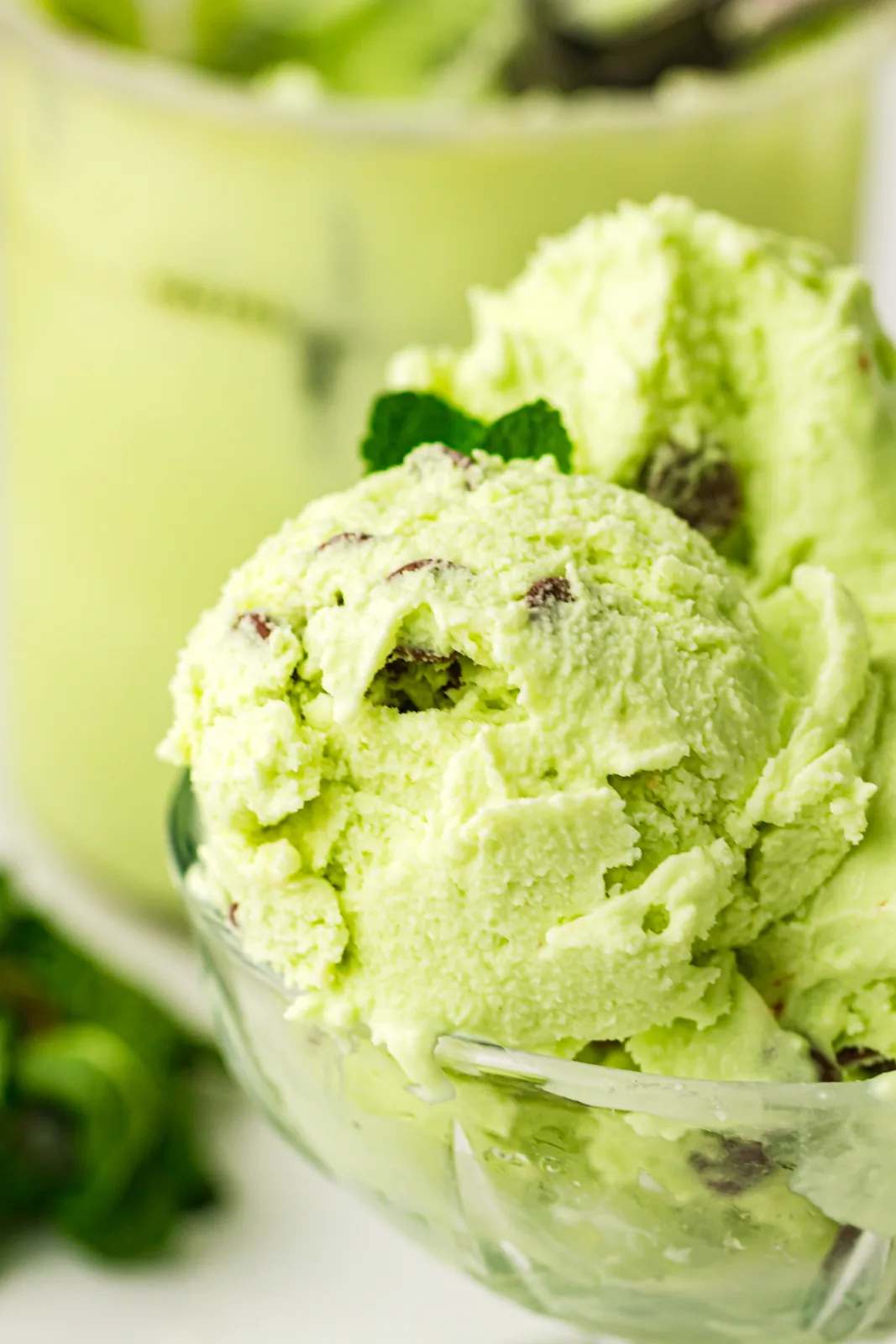 Mint chocolate chip ice cream scoops in a glass dish