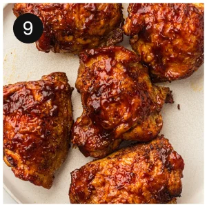 Finished BBQ-glazed dark meat resting on a cream plate