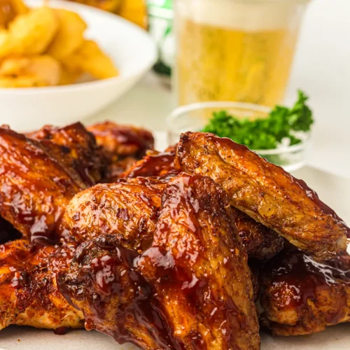 Smoked chicken wings glazed with BBQ sauce on a plate
