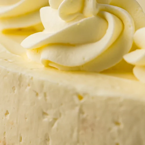 A creamy no bake cheesecake topped with whipped cream swirls