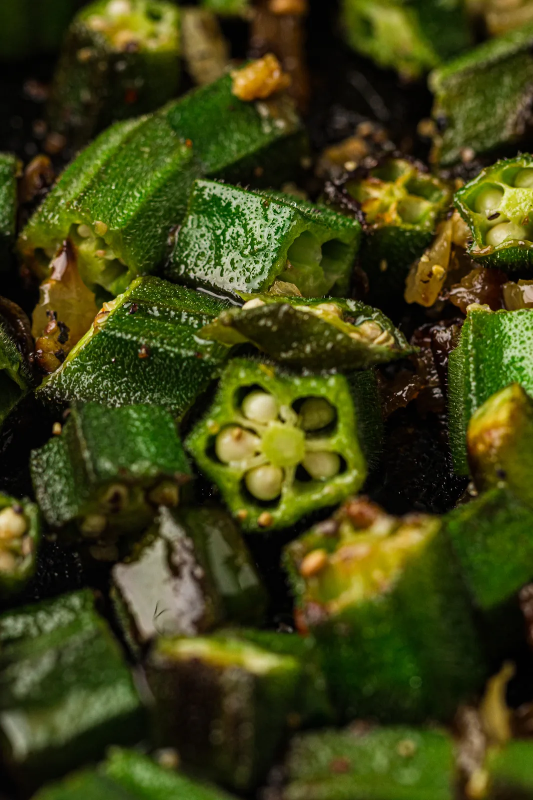 A close-up of golden, blistered okra pieces