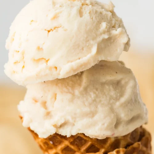 High protein vanilla ice cream stacked on a waffle cone