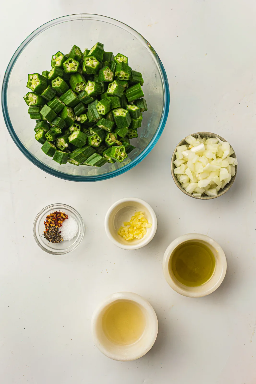 Ingredients for sauteed okra: okra, onion, garlic, chili, and lemon