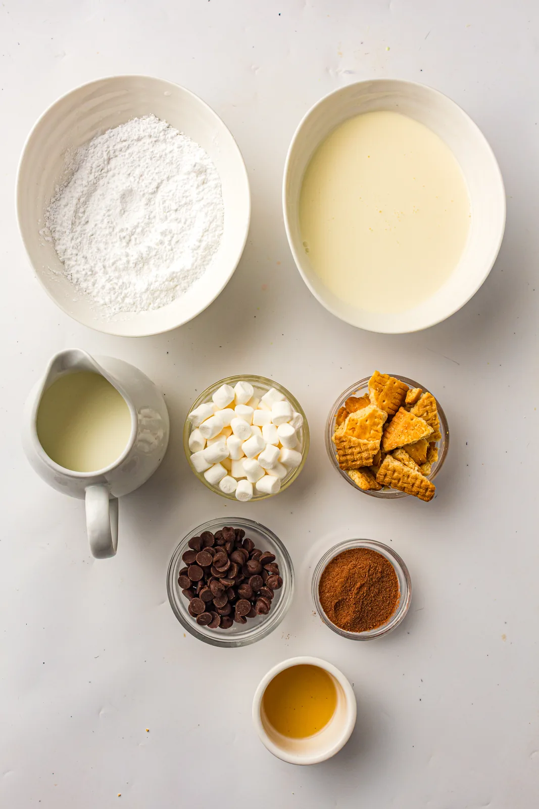 Ingredients for s'mores ice cream: milk, cream, cocoa, graham crackers, marshmallows, and chocolate