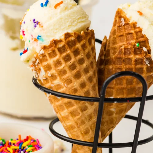 Vanilla ice cream on waffle cones with sprinkles