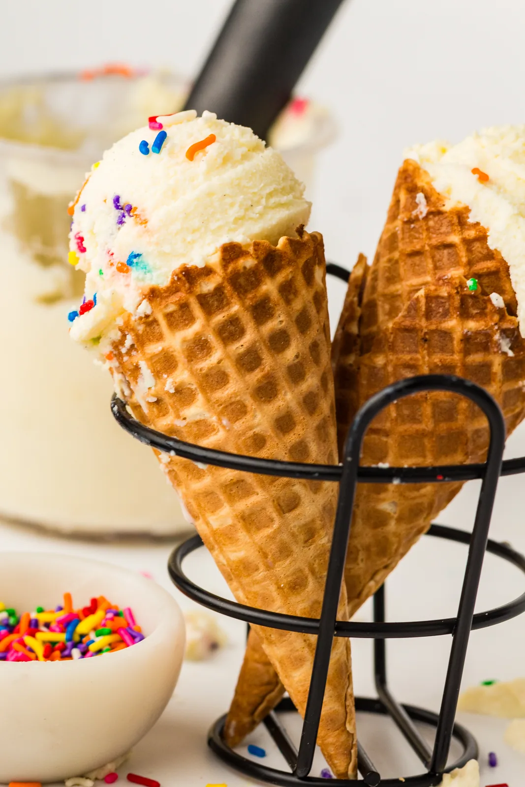 Vanilla ice cream on waffle cones with sprinkles