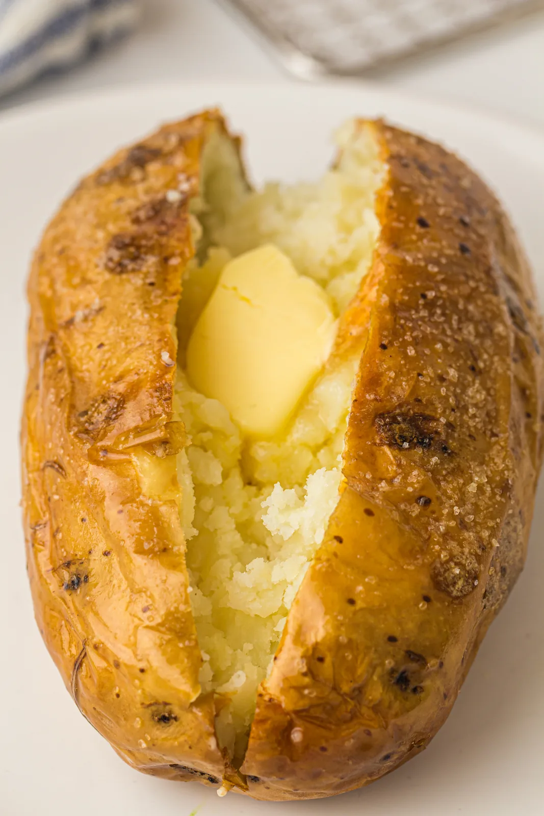 Air fryer baked potato split open with a fluffy interior