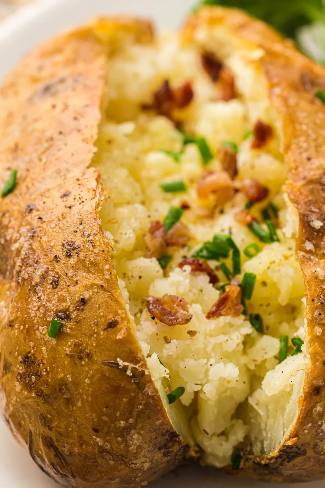 Split potato steaming with butter melting into the centre