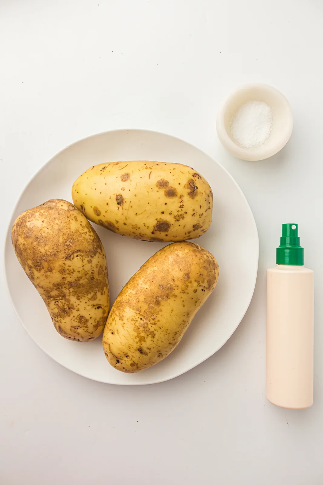 Ingredients for air fryer baked potato: russet potatoes, oil and salt
