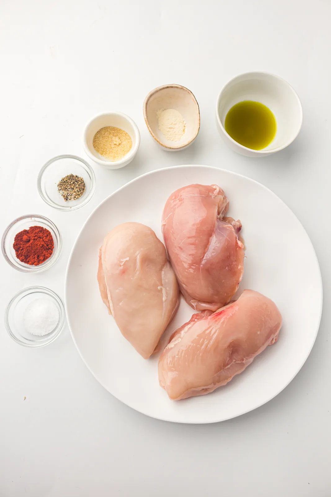 Ingredients for air fryer chicken breast: chicken, smoked paprika, salt, pepper and oil