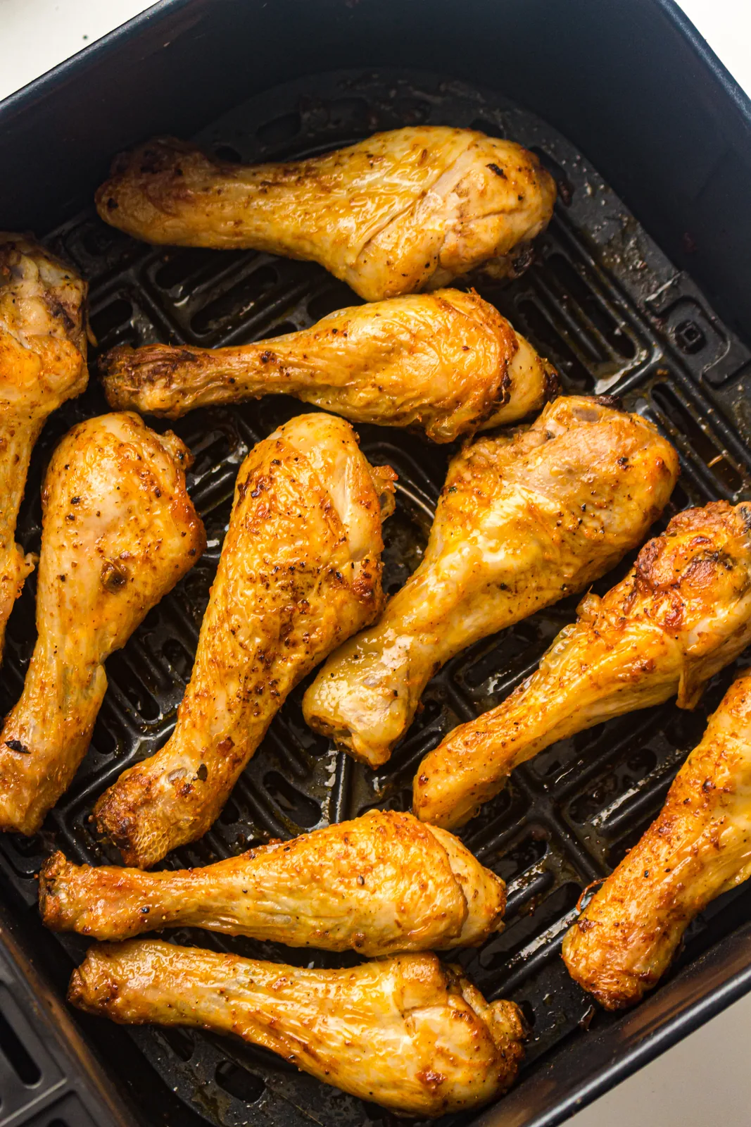 Close up of crisp seasoned skin on cooked chicken legs