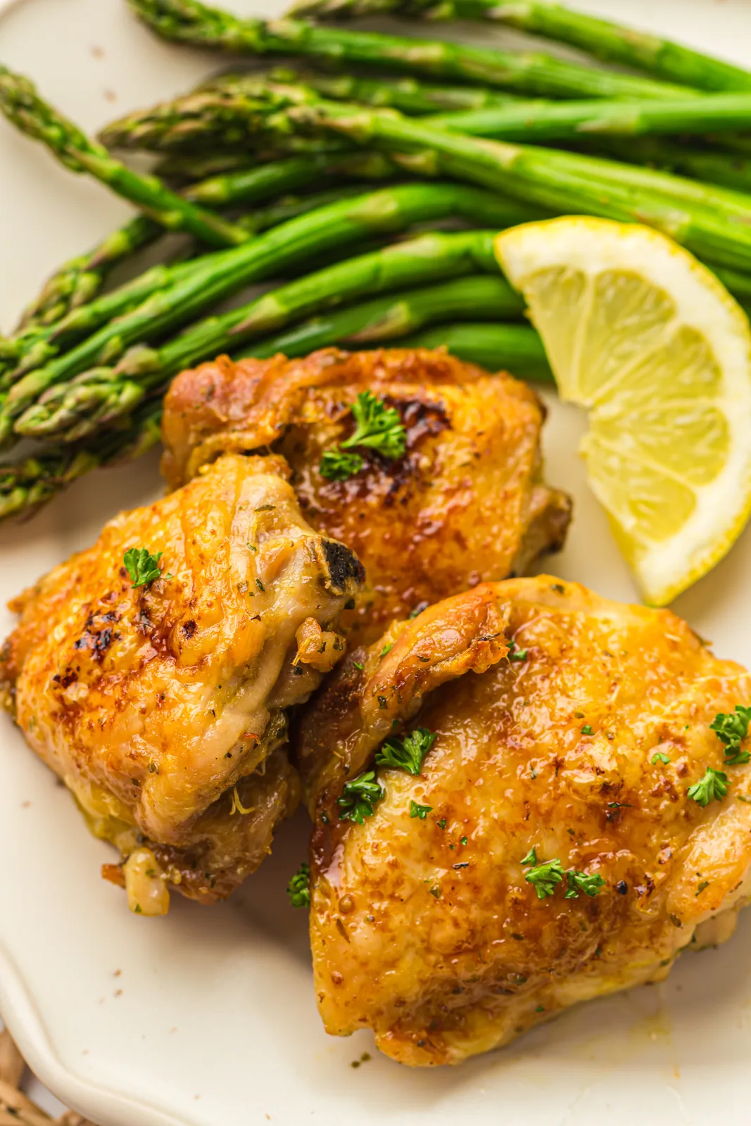 Air fryer chicken thighs with crisp golden skin on a plate