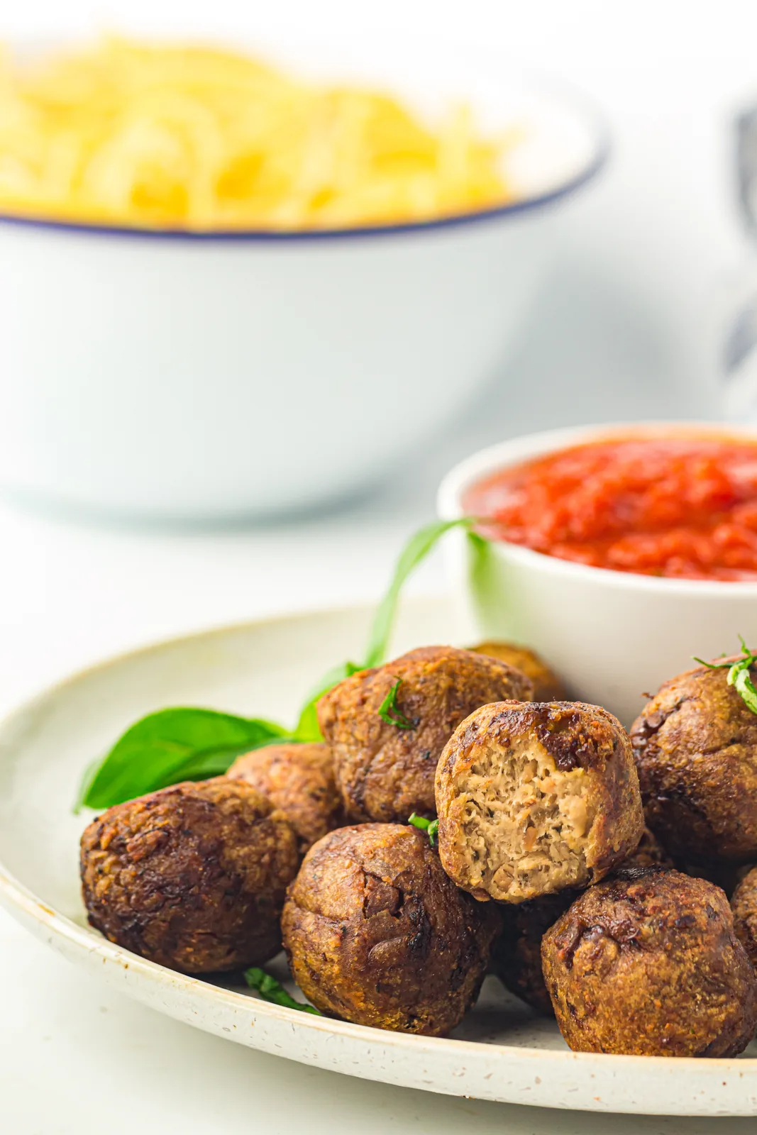 Air fryer frozen meatballs browned and piled on a plate