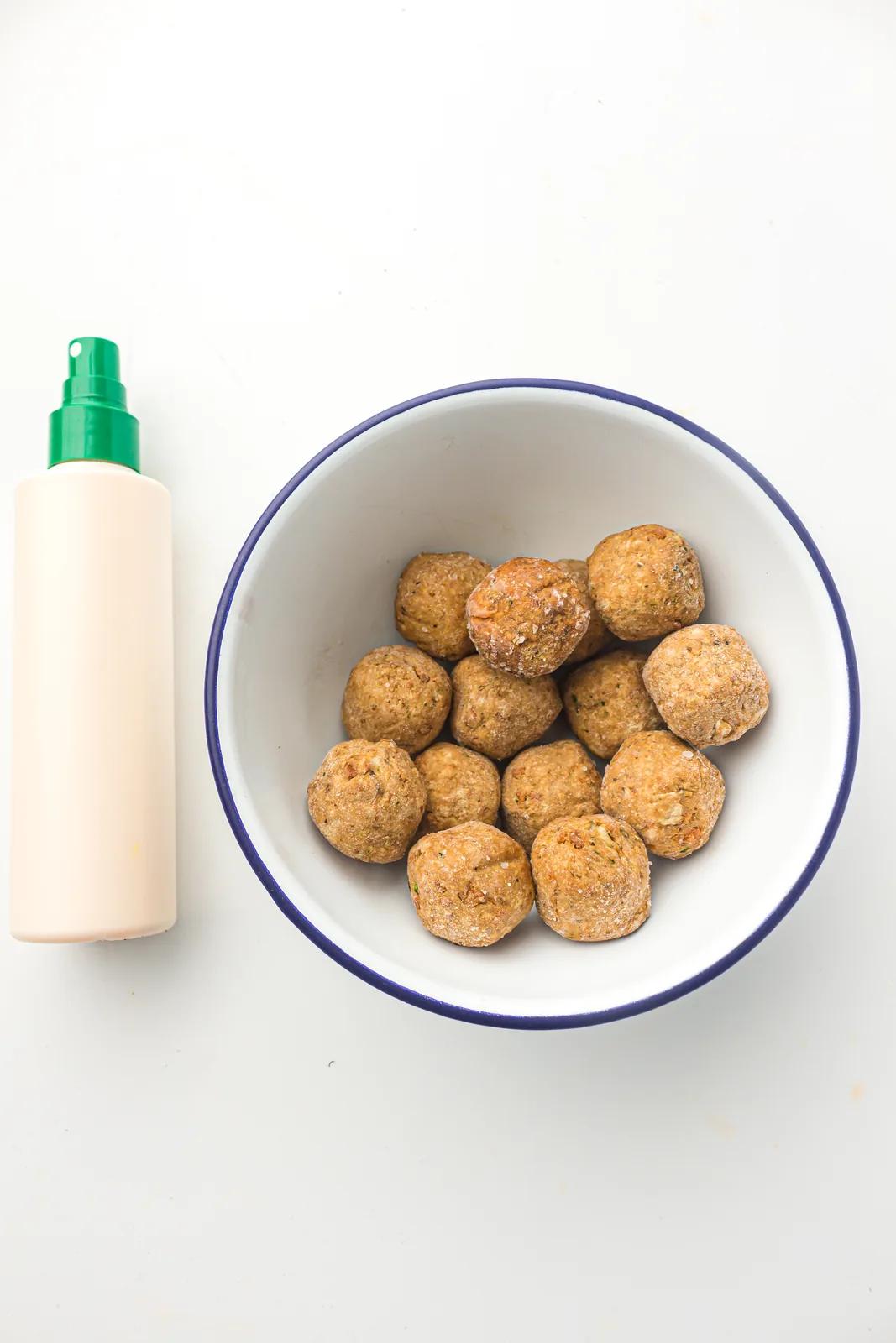Ingredients for air fryer frozen meatballs: a bag of frozen meatballs and spray oil