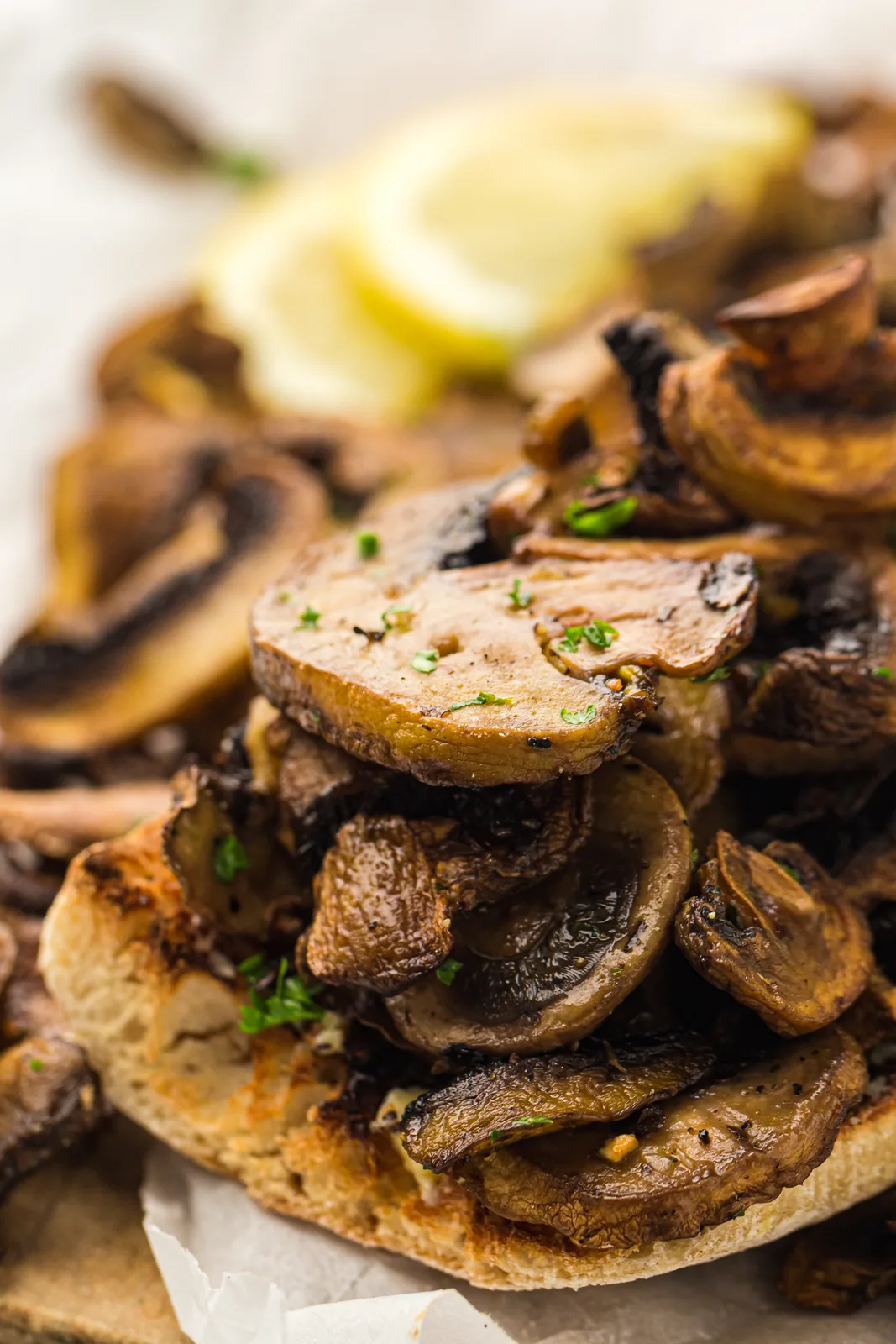 Garlicky browned slices piled onto toasted sourdough with a wedge of lemon