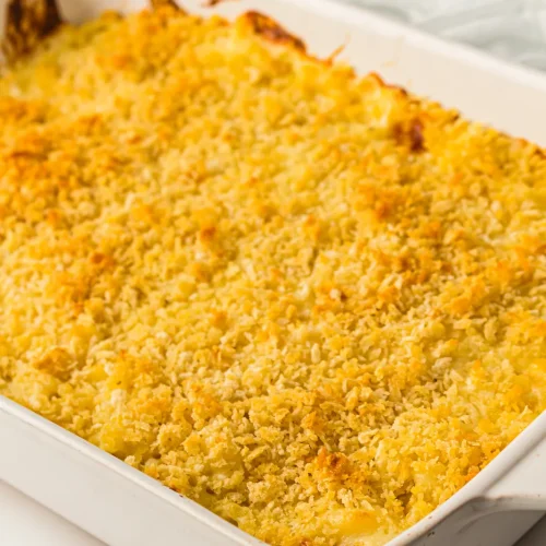 Baked mac and cheese in a white dish with a golden breadcrumb crust