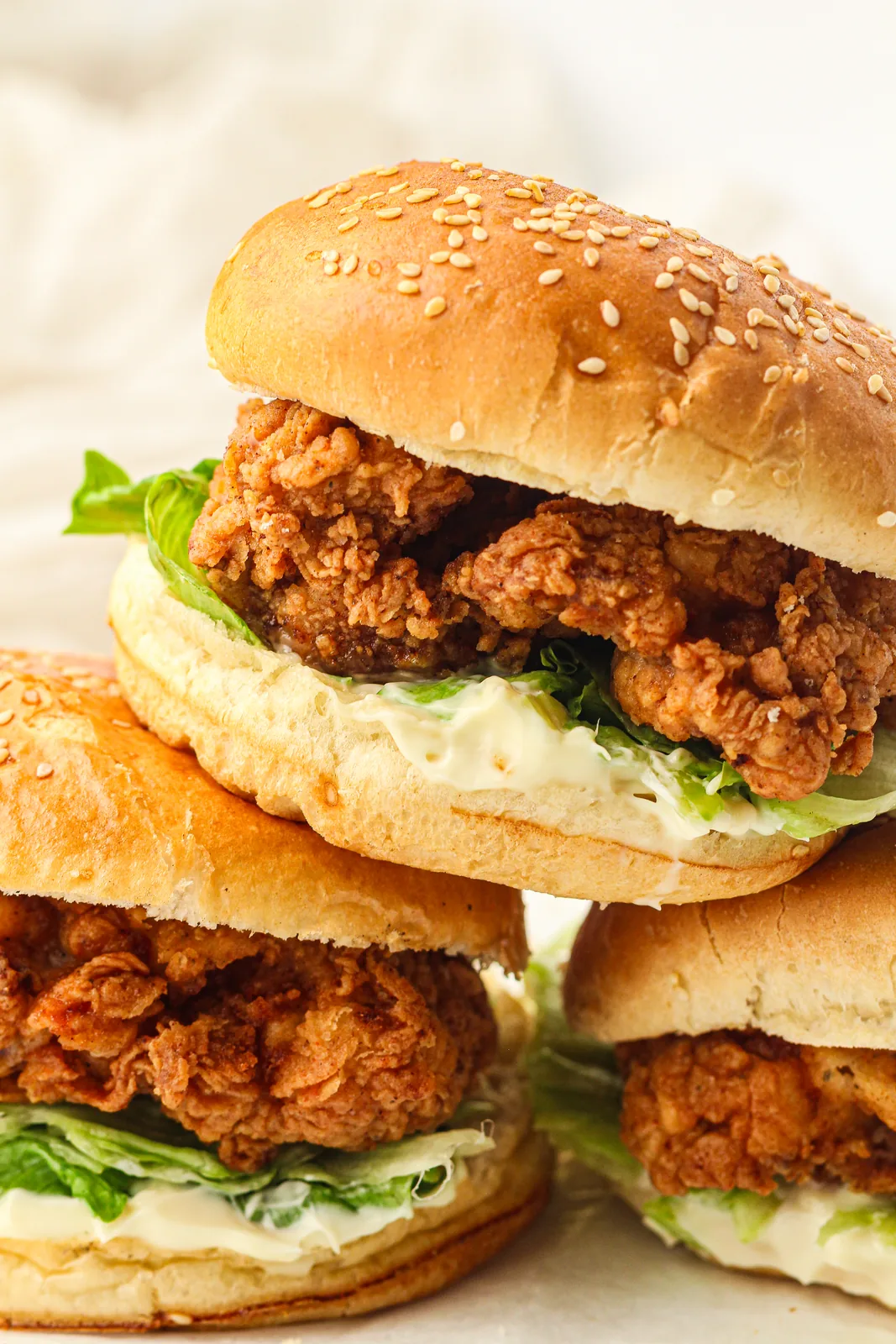 Crispy chicken burger stacked with lettuce and mayonnaise in a sesame bun