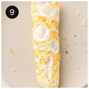 A finished roll on a board, tightly wrapped around its filling