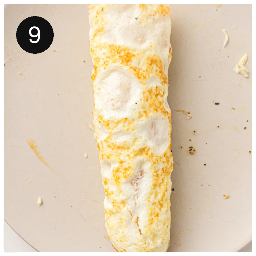 A finished roll on a board, tightly wrapped around its filling