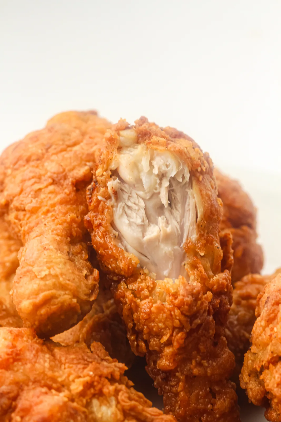 Close up of a golden crust broken open to show the juicy white meat underneath