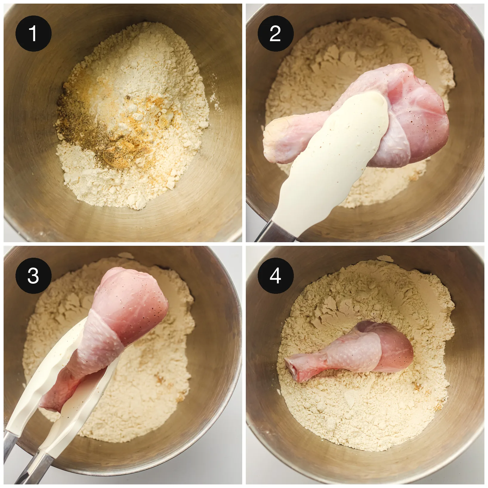 Seasoned flour in a metal bowl with a raw leg being turned and pressed into the coating