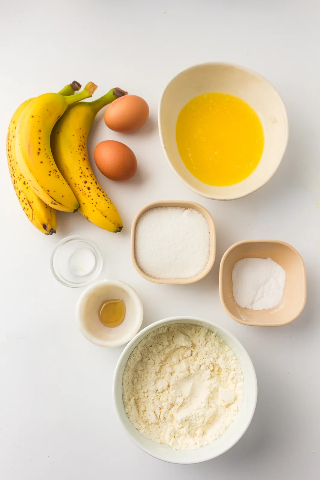 Ingredients for gluten free banana bread: ripe bananas, eggs, butter, sugar and flour