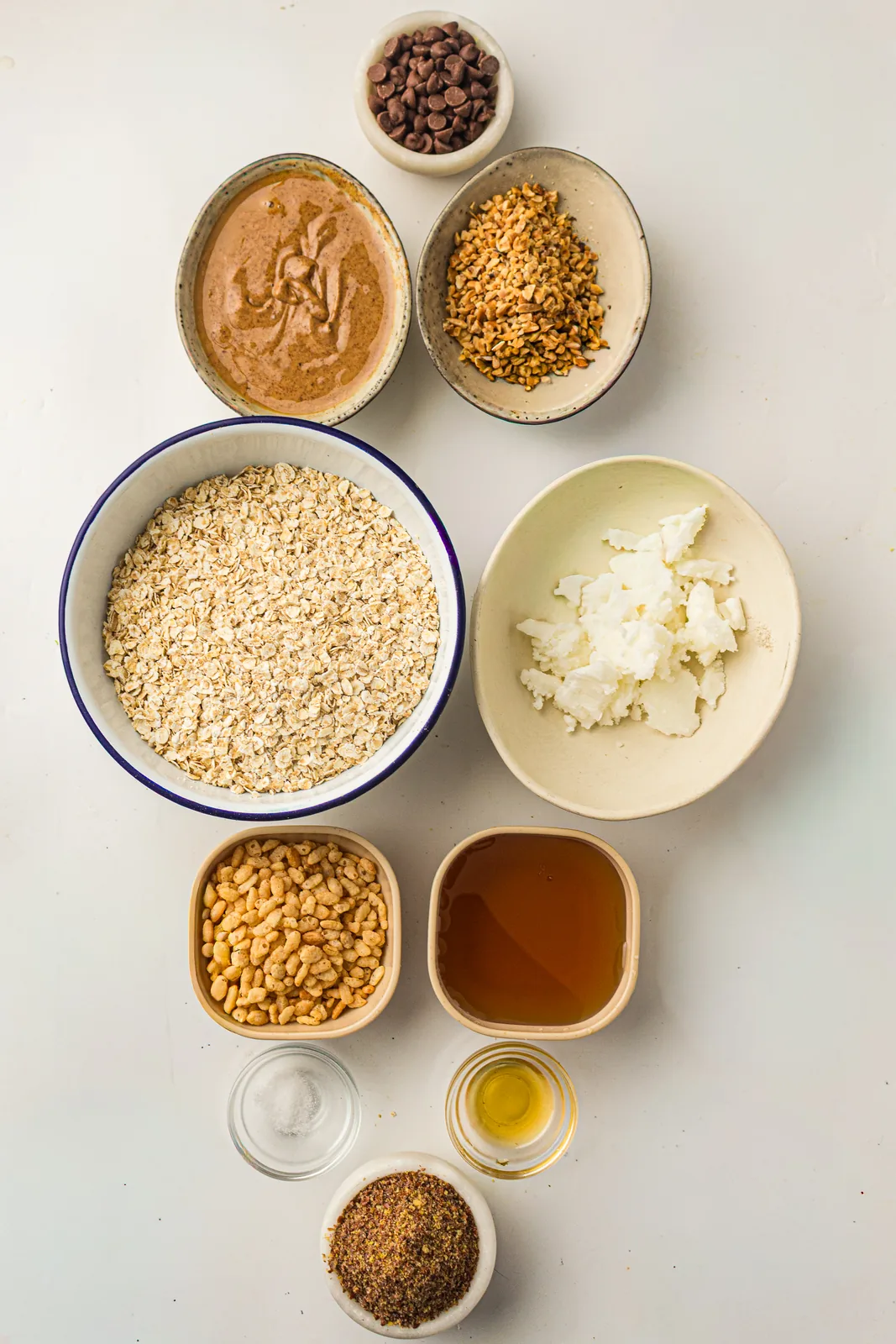 Ingredients for granola bars: rolled oats, honey, almond butter, flaxseed and chocolate chips