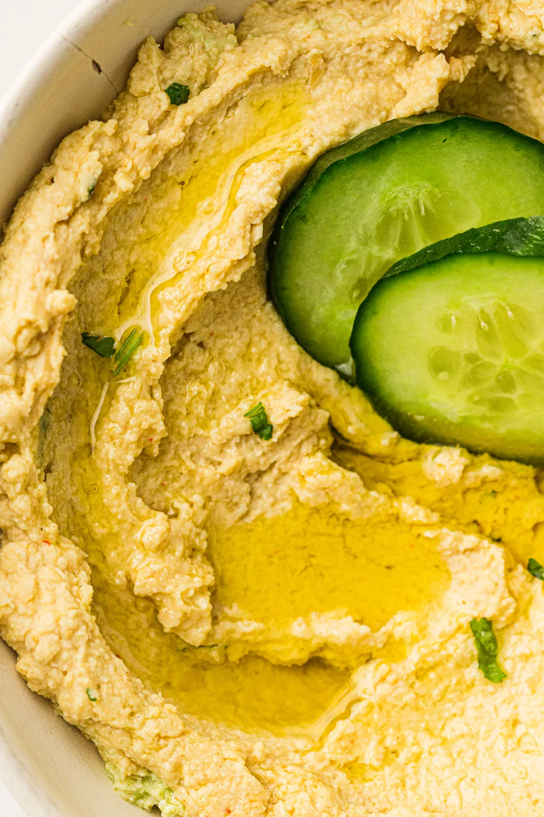 A smooth chickpea dip served with cucumber slices
