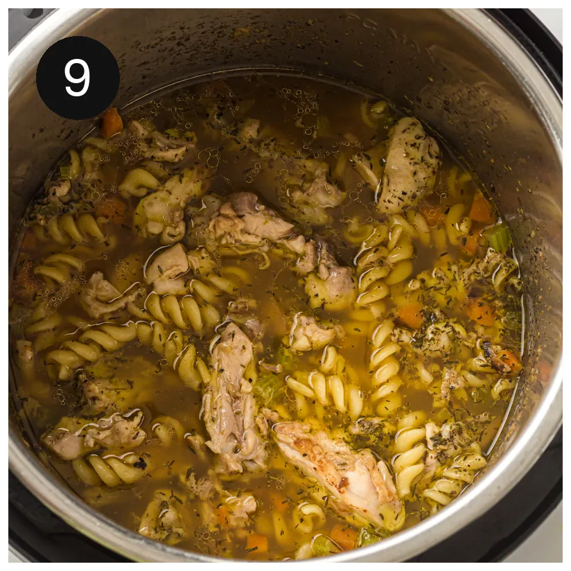 Finished soup in the pressure cooker insert, spirals and chicken in golden broth