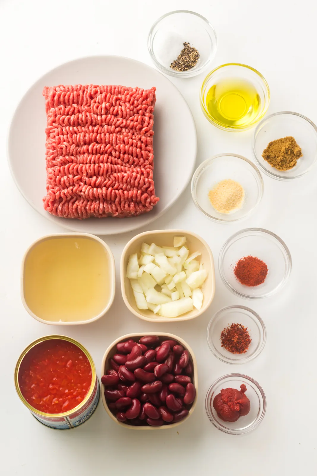 Ingredients for instant pot chili: ground beef, kidney beans, diced tomatoes, onion and warm spices