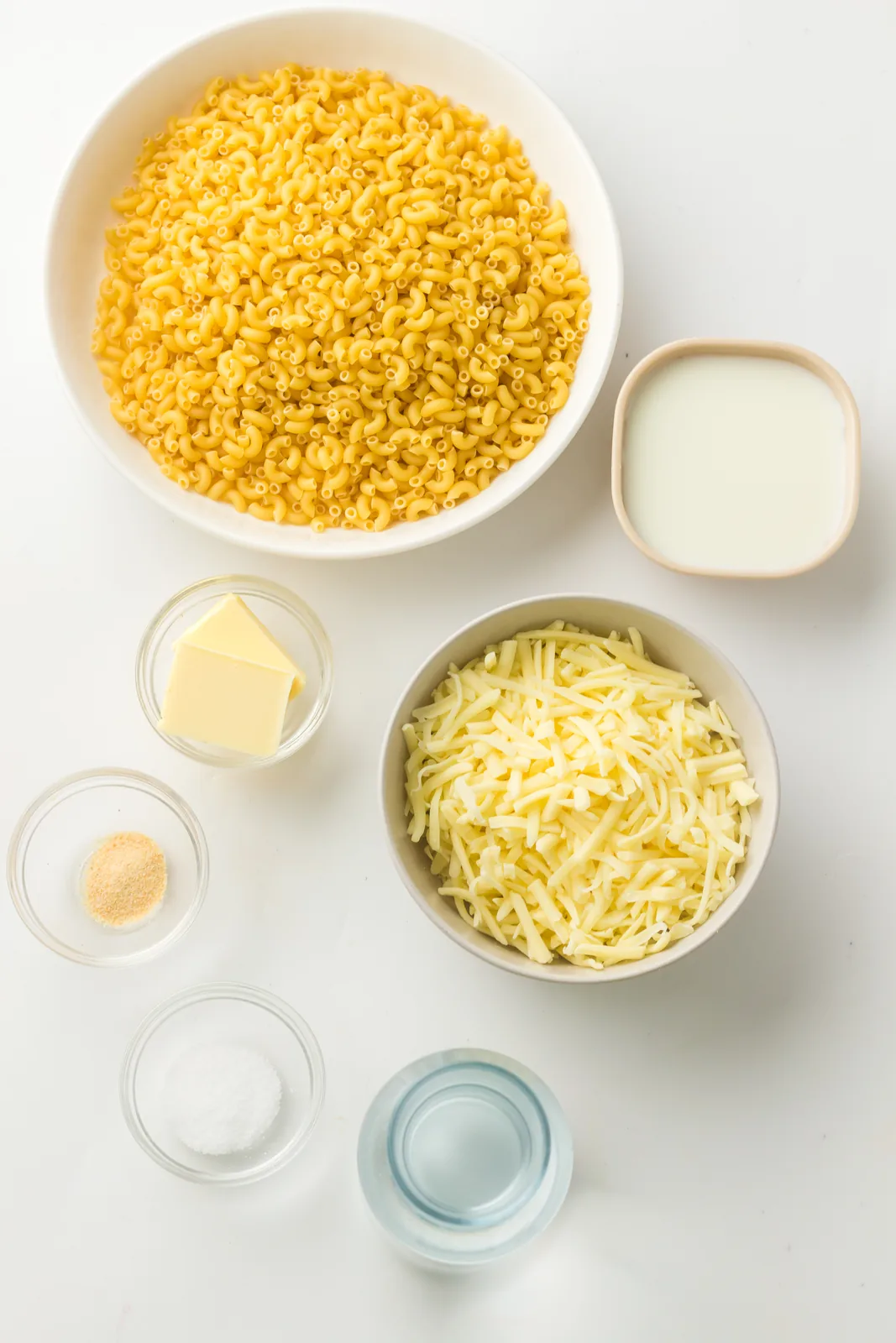 Ingredients for instant pot mac and cheese: dry elbows, shredded cheddar, milk, butter and garlic powder