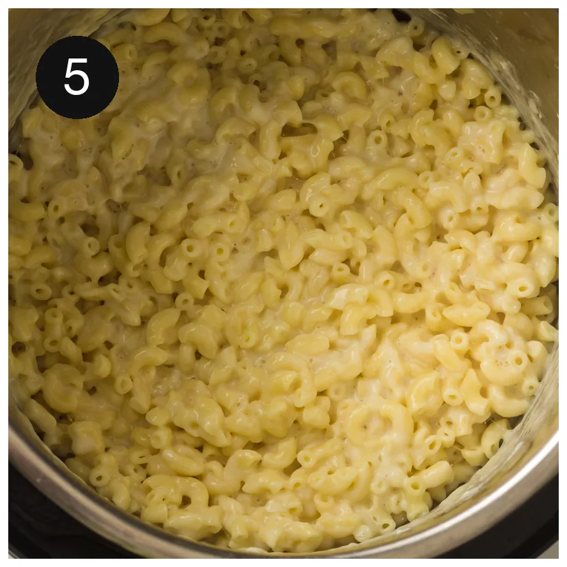 The finished creamy pasta in the pressure cooker insert, glossy and fully coated