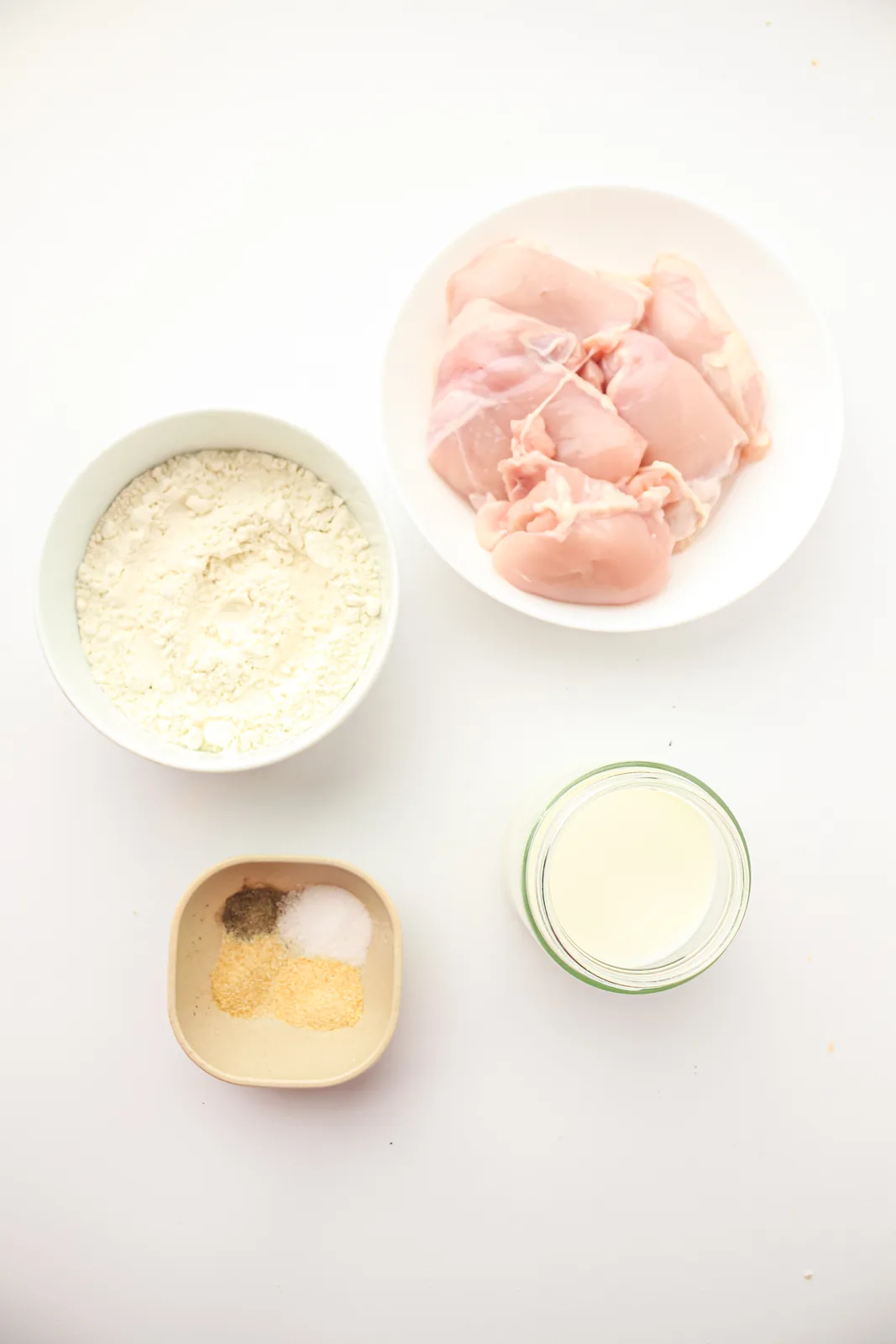 Ingredients for popcorn chicken: diced chicken, milk, flour, salt, black pepper, garlic powder and onion powder